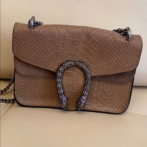 Small croc embossed leather crossbody bag.